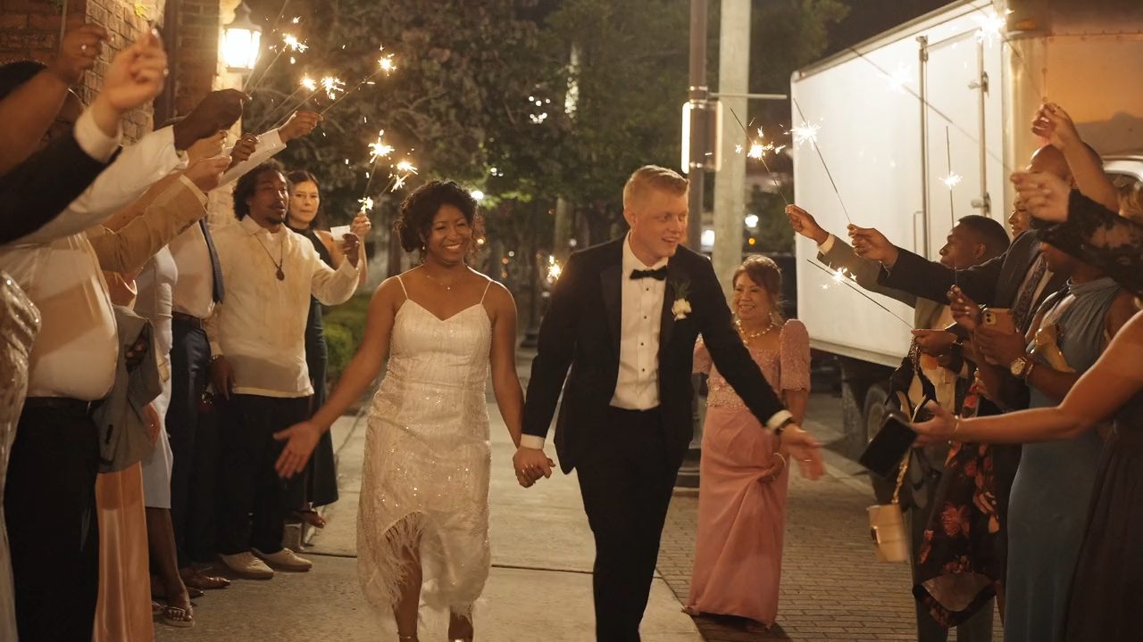 A newly married couple walking through a sparkler send-off